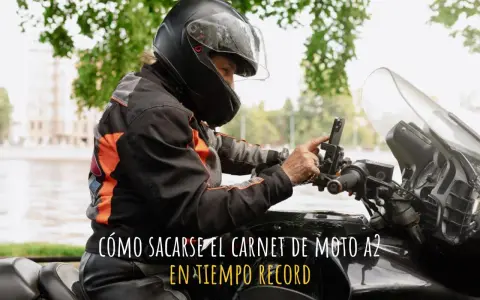 Persona con casco y chaqueta de moto ajustando su móvil en el manillar. ¿Cuánto se tarda en sacar el carnet de moto A2?