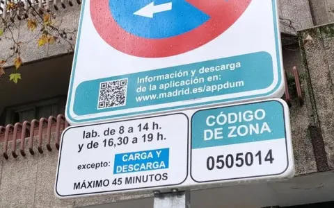 Señal de tráfico de carga y descarga con horarios y código de zona.