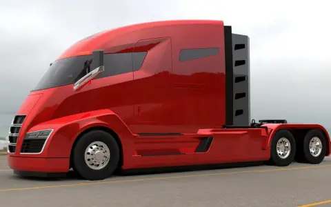 Camiones Nikola, un tractor rojo brillante con diseño futurista, listo para la carretera.