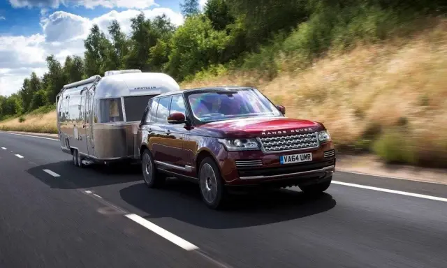Range Rover rojo arrastra una caravana Airstream. Con el carnet B+E, puedes llevar este tipo de remolque.