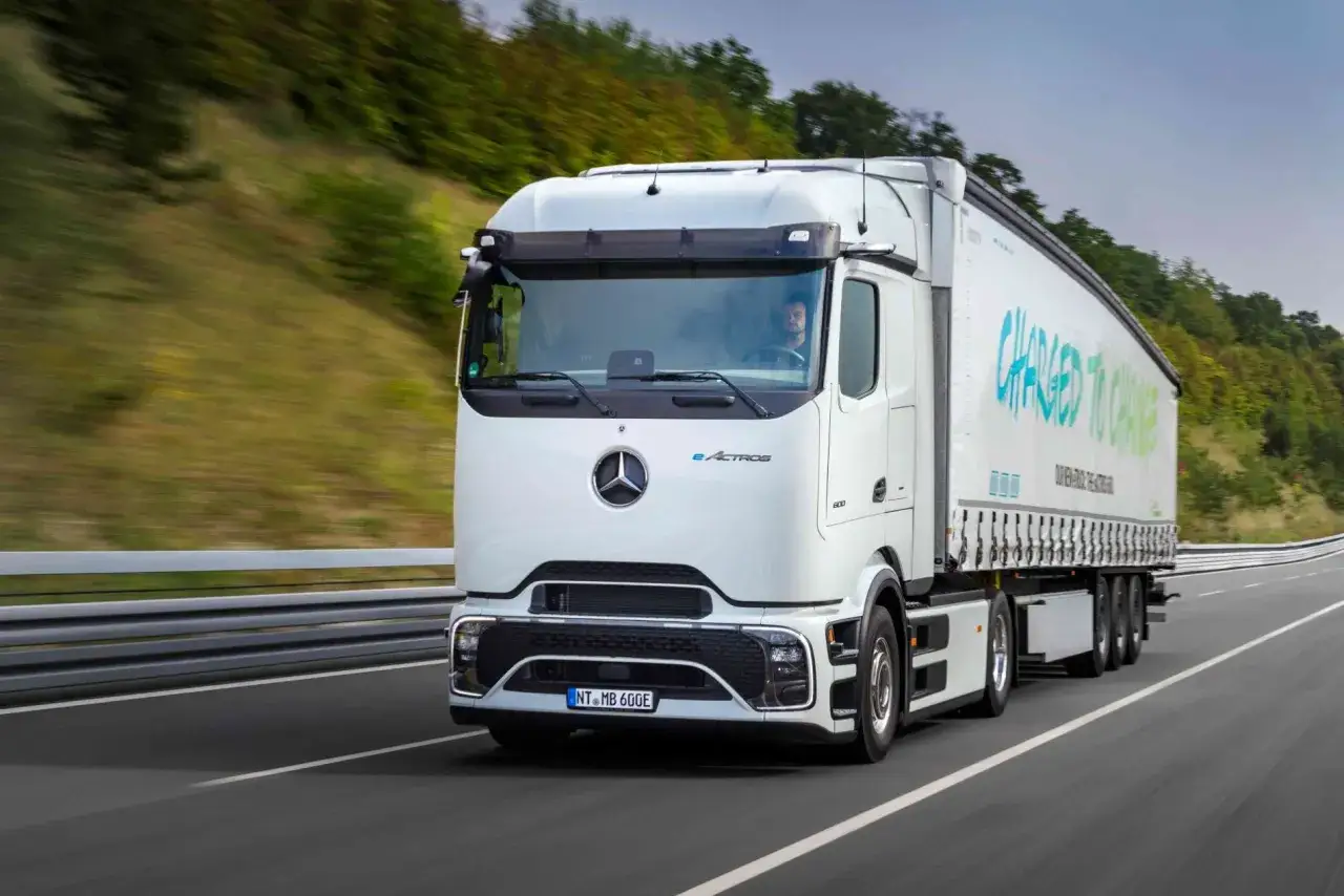 Un nuevo camión Mercedes eActros avanza por una carretera, con el lema 